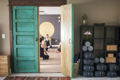 Photograph of an open turquoise door to yoga studo