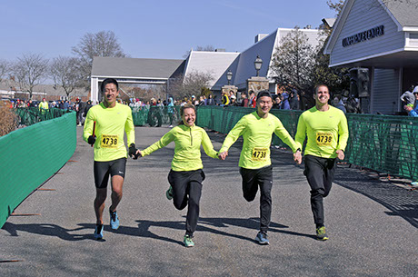 Photograph of 4 runners in the Hyannis marathon wearing neon shirts