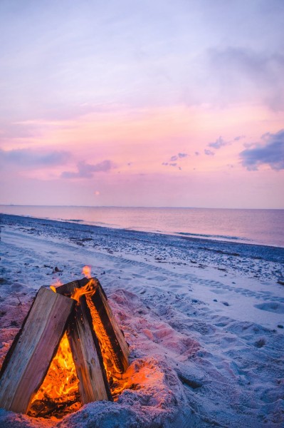 Photograph of Sandy Neck Beach camp fire with sunset in the background